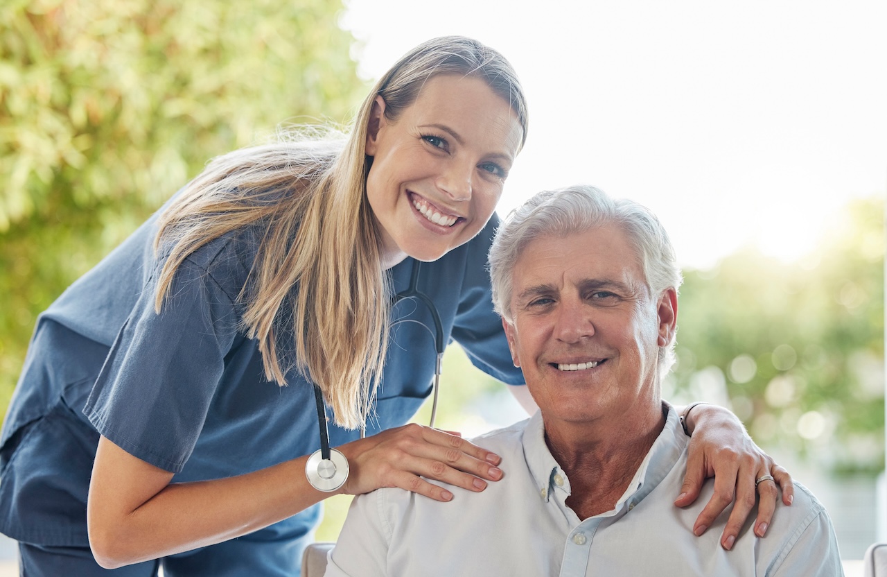 A happy smiling man and woman showing the bond between patient and doctor during a checkup at home.